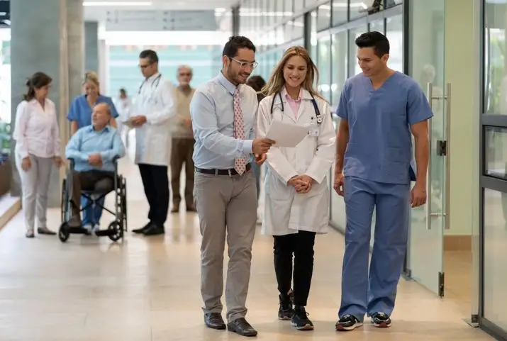 A group of medical professionals walking together down a hospital hallway.