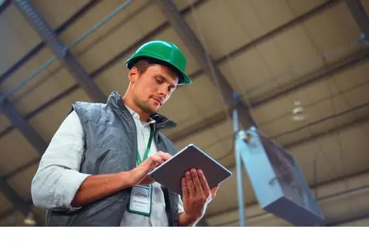 Facility project manager viewing training software on a tablet
