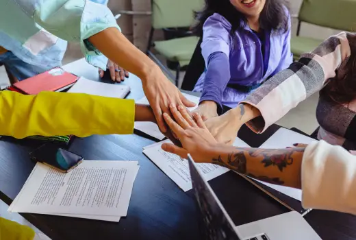 A group of people put their hands together